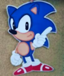 Afiche grande troquelado de Sonic el erizo en azul, blanco y rojo, señalando